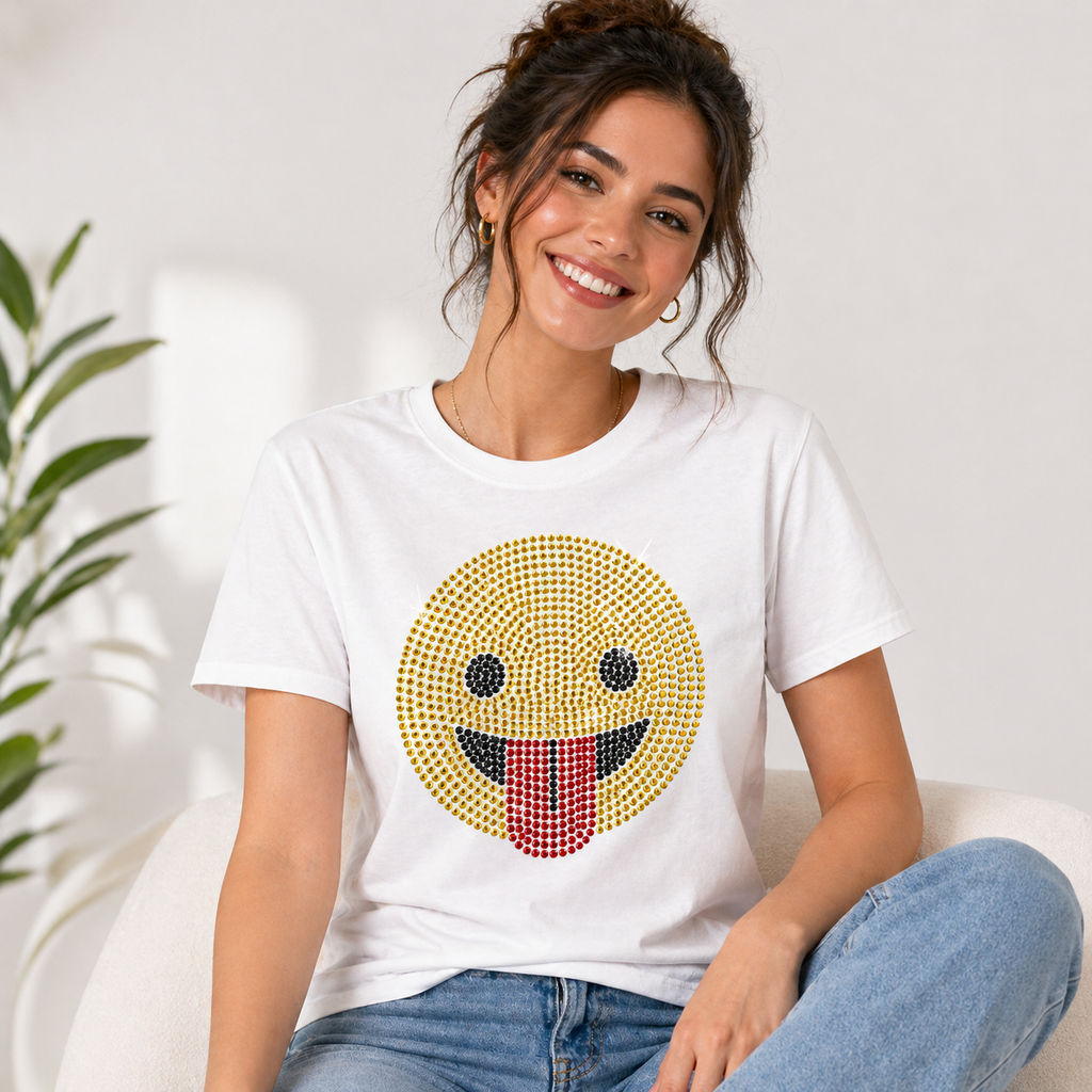 Funny tongue-out emoji rhinestone heat transfer sticker made with yellow, black, and red glass crystal stones for T-shirts, kidswear, bags, and apparel decoration.