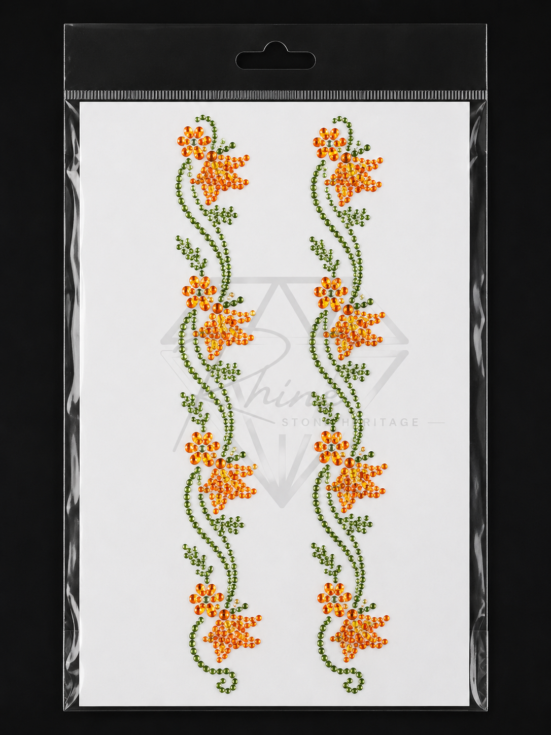 Packaged cross-stitch pattern with orange flowers on a white background